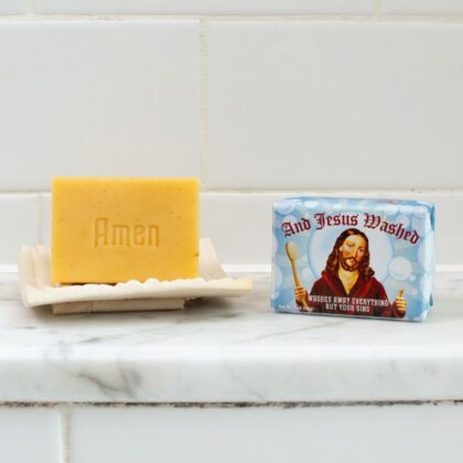 Opened package of Jesus Soap showing the almond and cocoa butter scented novelty bar inside its humorous Jesus-themed packaging