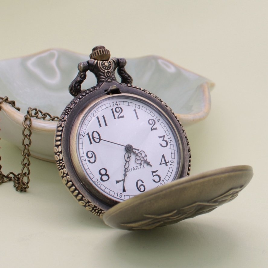 Gold ship pocket watch necklace opened to show the clock face inside.